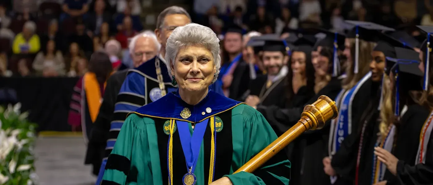 U N E faculty member Marilyn R. Gugliucci,  Ph.D., Geriatrics Education and Research, leads the procession into commencement